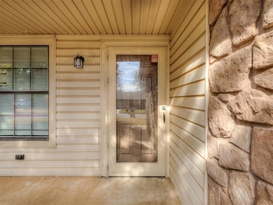 View of exterior entry featuring stone siding