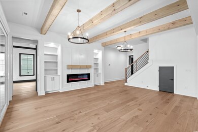 Unfurnished living room featuring built in feature