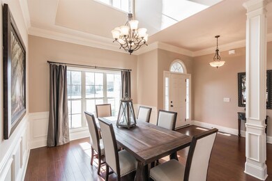 You'll find an open dining space with high ceilings and lovely trim!