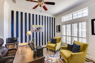 Sitting room with ornamental molding and ceiling f