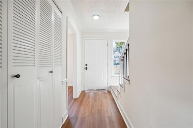 Entryway featuring stairway, wood finished floors,