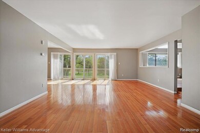 Unfurnished living room with light wood-type flooring and baseboards