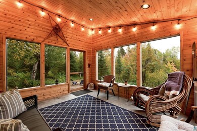 Sunroom featuring lofted ceiling, wood ceiling, an