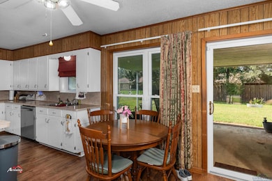 Dining area with dark wood-type flooring, sink, wo