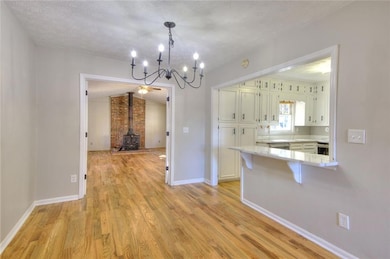 Kitchen featuring a wood stove, light hardwood / w
