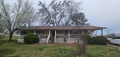 View of front of home featuring a front yard and a porch