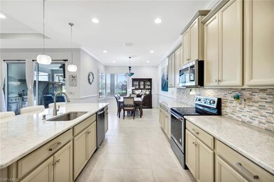 Kitchen with light tile patterned floors, stainles