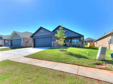 Craftsman-style house featuring an attached garage, driveway, a front yard, and brick siding