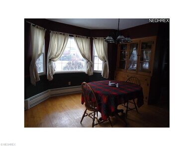 Dining room with angled window and built-in hutch.