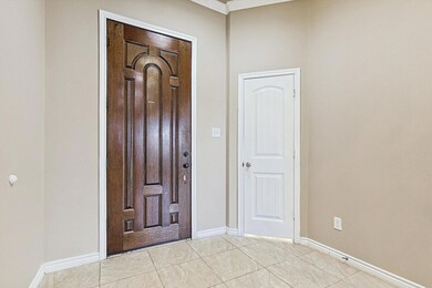 Foyer entrance with light tile patterned floors an