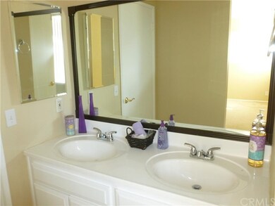 Master bath with dual sinks and framed mirror