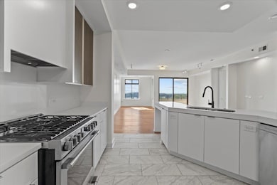 Kitchen featuring light countertops, appliances wi