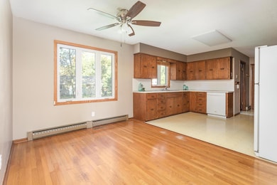 Natural oak hardwood floors in dining room and front entry.