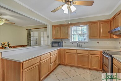 The spacious and cheery kitchen features abundant 