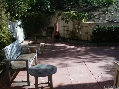 Large patio adjacent to hillside greenbelt and tre