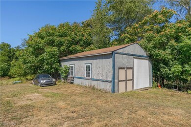 View of shed featuring view of scattered trees