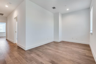 Unfurnished room featuring light wood-style floori