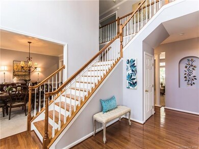 Grand 2 story foyer with hardwood floors and stair