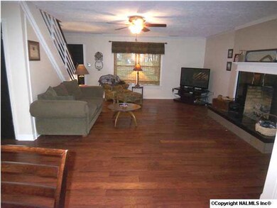 Greatroom features fireplace, new hand scraped hickory floors, crown mold and updted lighting.