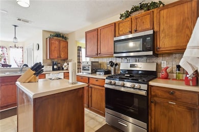 Kitchen featuring tasteful backsplash, a textured 