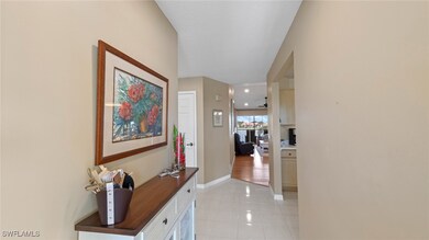 Hall with light tile patterned flooring and basebo