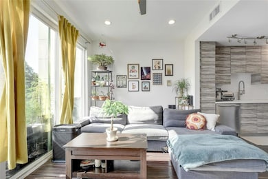 Living room with a ceiling fan, recessed lighting