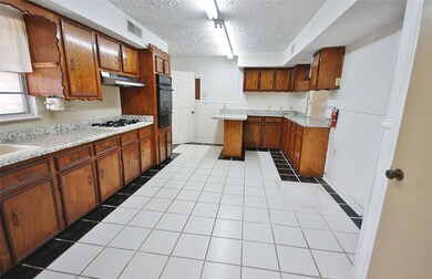 LEFT SIDE OF KITCHEN FEATURES A PREP AREA THAT COULD BE USED AS A WET BAR