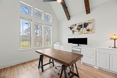 A private study through double glass doors adds a