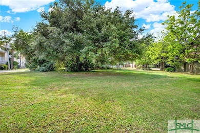The large oak is on the edge of the lot and will n