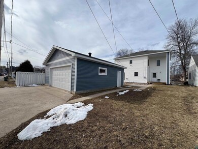 Exterior space featuring an outbuilding, fence, and a detached garage