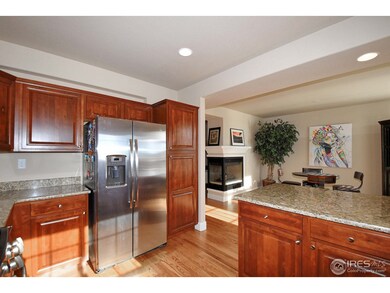 Kitchen showing 3 sided fireplace & breakfast area