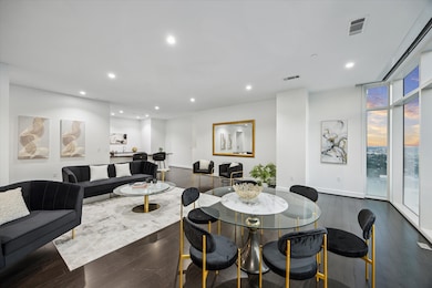 View of family room with wet bar in the back round.