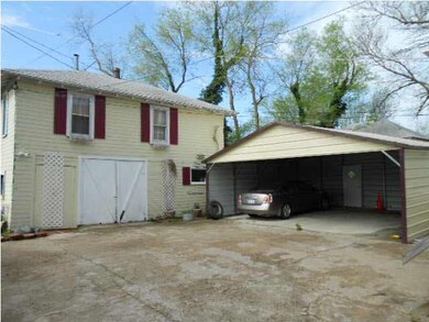 GARAGE WITH AN APPARTMENT UP STAIRS AND A CAR PORT