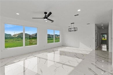 Spare room featuring ceiling fan and light tile floors