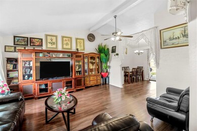 Living room featuring beamed ceiling, high vaulted
