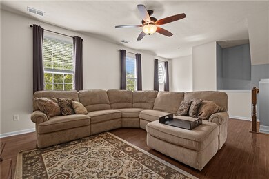 A spacious living room with a beautiful hardwood f