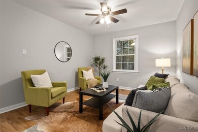 Living room featuring ceiling fan and hardwood / w