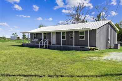 View of front of home with a front lawn, board and