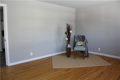 Through the front door you are greeted with a large living room with beautiful hardwoods and fresh paint!