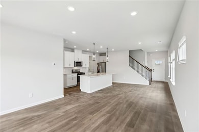 Unfurnished living room with hardwood / wood-style