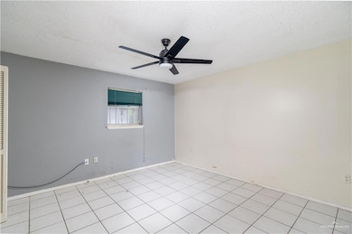 Spare room featuring a ceiling fan and a textured ceiling