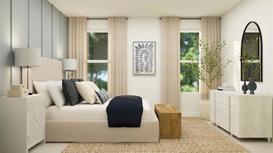 Bedroom featuring light colored carpet