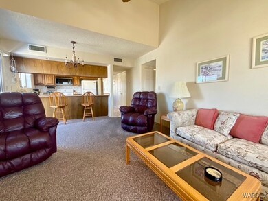 Living area with carpet floors, visible vents, a c