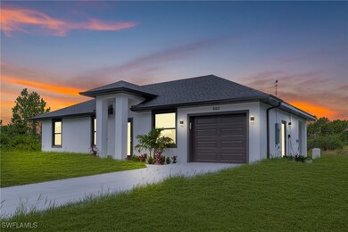 View of front of home with a garage, concrete driv
