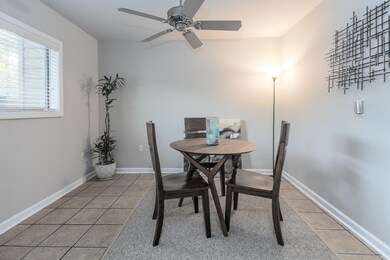 Dining space featuring ceiling fan and tile patter