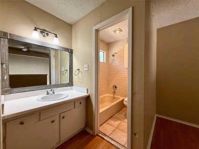 Bathroom featuring a textured ceiling, a ceiling 