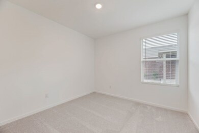 Carpeted spare room with baseboards and recessed lighting