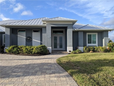 Entrance to property featuring metal roof, french