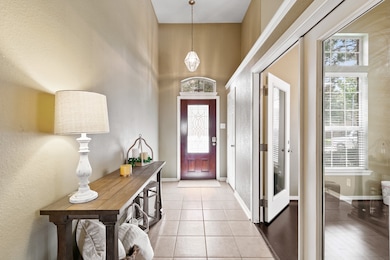 Beautiful entryway featuring high ceilings and a t