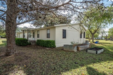View of side of property featuring a lawn